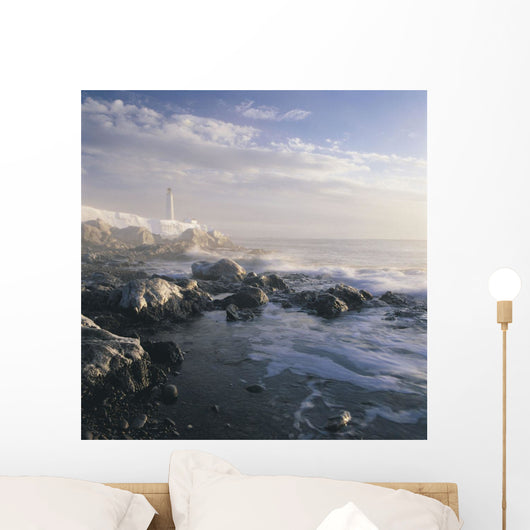 Fog And Rocky Shoreline In Winter With Cap Des Rosiers Lighthouse Wall Mural