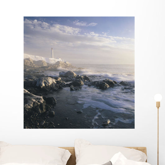 Fog And Rocky Shoreline In Winter With Cap Des Rosiers Lighthouse Wall Mural