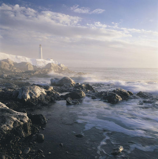 Fog And Rocky Shoreline In Winter With Cap Des Rosiers Lighthouse Wall Mural