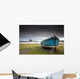 A Weathered Boat Sitting On The Shore With Lindisfarne Castle Wall Mural
