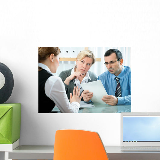 mid-adult couple meeting with financial planner Wall Mural