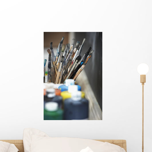 Paint Brushes And Paint Containers In A Classroom Wall Mural
