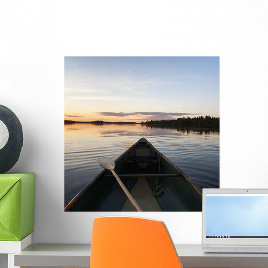 A Boat And Paddle On A Tranquil Lake At Sunset Wall Mural