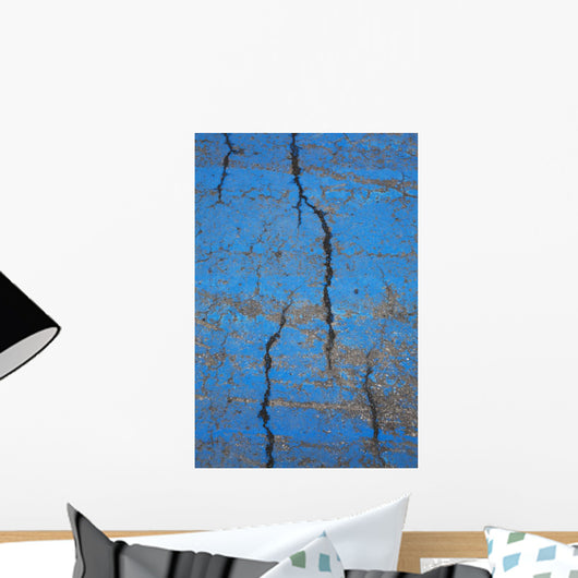 Close Up Of Cracks On A Blue Painted Asphalt Surface Wall Mural