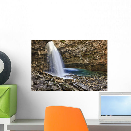 A River Cascades Over A Small Waterfall Wall Mural