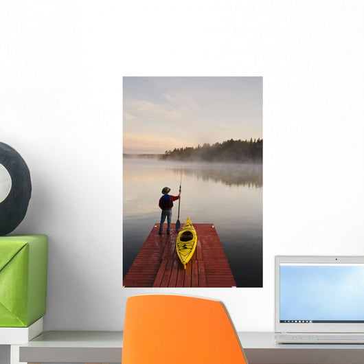 Man Standing By Kayak On Dock In Northwestern Ontario Wall Mural