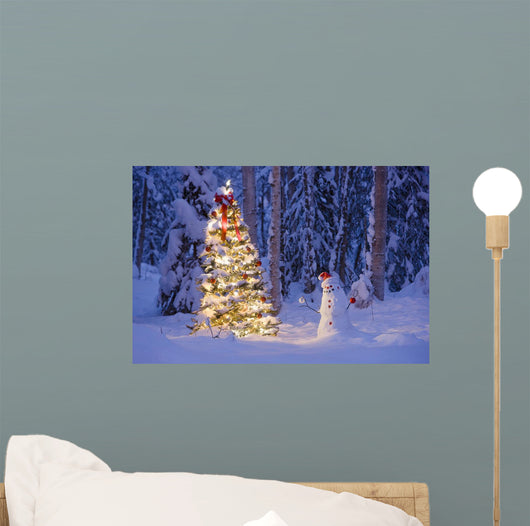 Snowman With Santa Hat Hanging Ornaments On A Christmas Tree Wall Mural
