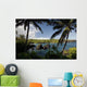 Hawaii, Maui, A sunny view of Waianapanapa from behind palm trees Wall Mural