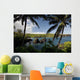 Hawaii, Maui, A sunny view of Waianapanapa from behind palm trees Wall Mural