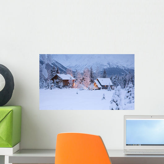 Two Snowcovered Homes In A Wintry Meadow At Dawn With Inside Lights On Wall Mural
