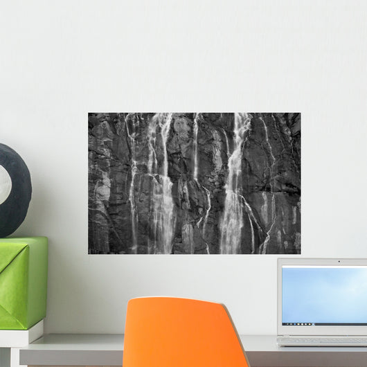 A Waterfall Cascades Over Rock Cliffs On The Juneau Ice Field Wall Mural