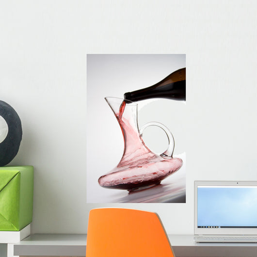pouring red wine into decanter Wall Mural