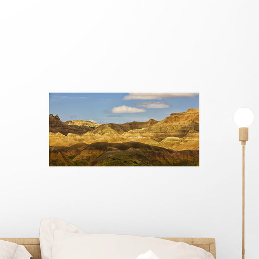 Dramatic light on the eroded formations of badlands national park Wall Mural