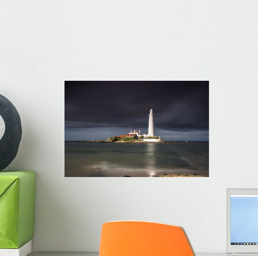 White Lighthouse Illuminated By Sunlight Under A Dark Stormy Sky Wall Mural