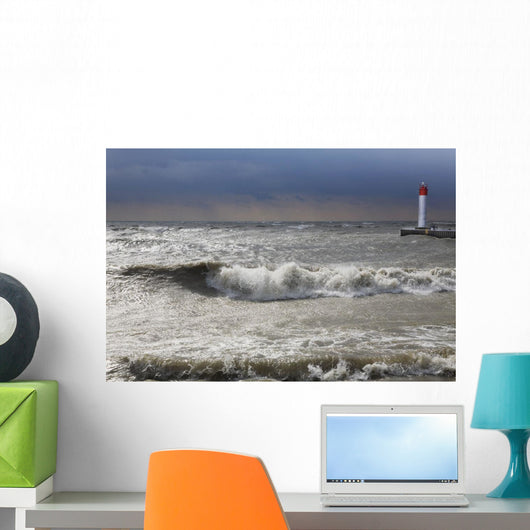 Storm waves crashing on a beach near a lighthouse on lake ontario Wall Mural