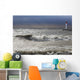Storm waves crashing on a beach near a lighthouse on lake ontario Wall Mural
