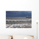 Storm waves crashing on a beach near a lighthouse on lake ontario Wall Mural
