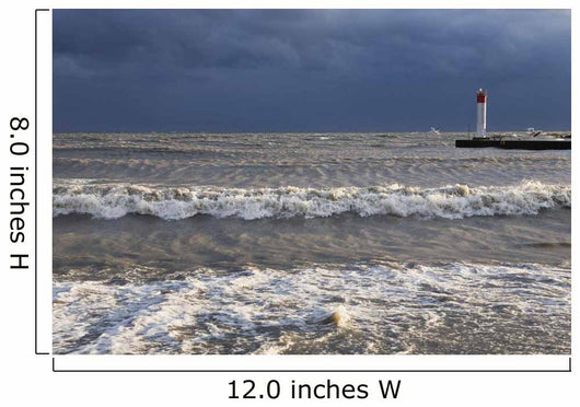 Storm waves crashing on a beach near a lighthouse on lake ontario Wall Mural