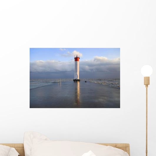 Lighthouse reflected on a wet pier on a stormy day by lake ontario Wall Mural