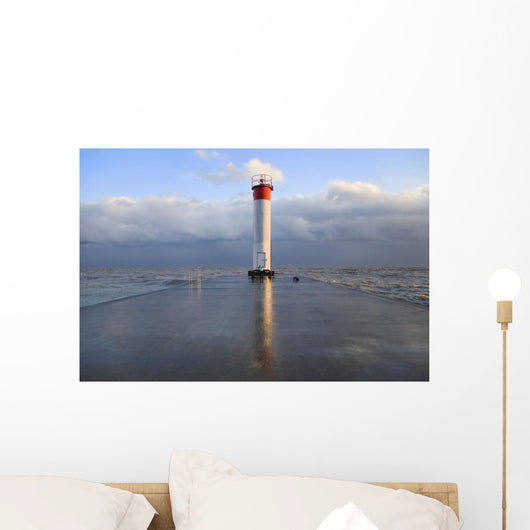 Lighthouse reflected on a wet pier on a stormy day by lake ontario Wall Mural