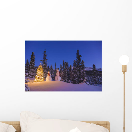 Two Snowmen Exchanging Gifts Standing Next To A Christmas Tree Wall Mural