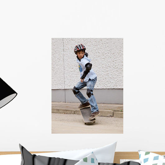 child skateboarding with helmet, knee pads and elbow protection Wall Mural
