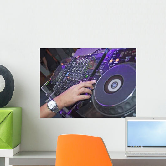 DJ mixing music on a mixer desk Wall Mural