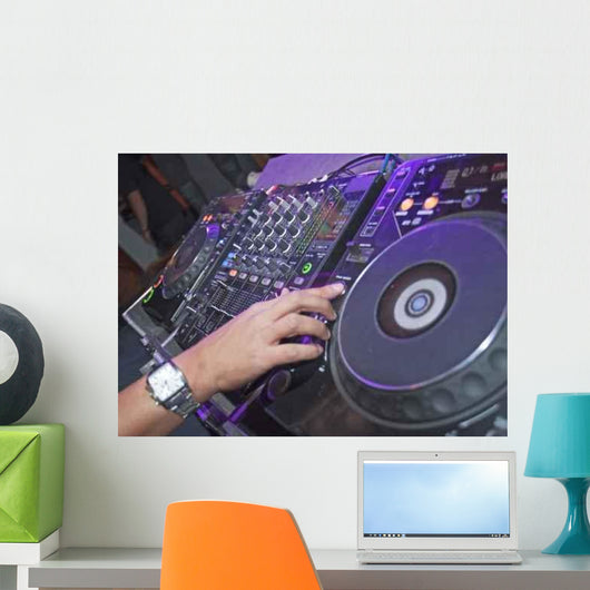 DJ mixing music on a mixer desk Wall Mural