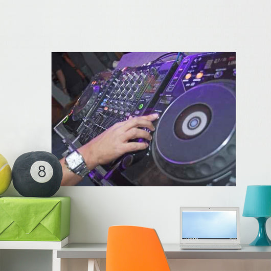 DJ mixing music on a mixer desk Wall Mural
