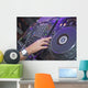 DJ mixing music on a mixer desk Wall Mural
