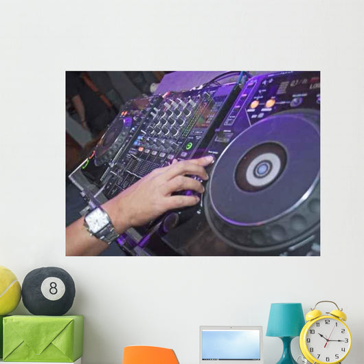 DJ mixing music on a mixer desk Wall Mural