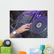 DJ mixing music on a mixer desk Wall Mural