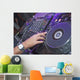 DJ mixing music on a mixer desk Wall Mural
