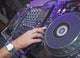 DJ mixing music on a mixer desk Wall Mural