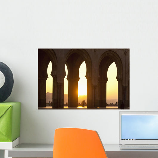 Morocco, Looking through arches of Hassan II mosque at dusk Wall Mural