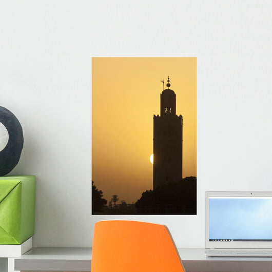 Morocco, Sun setting behind minaret of Koutoubia mosque Wall Mural