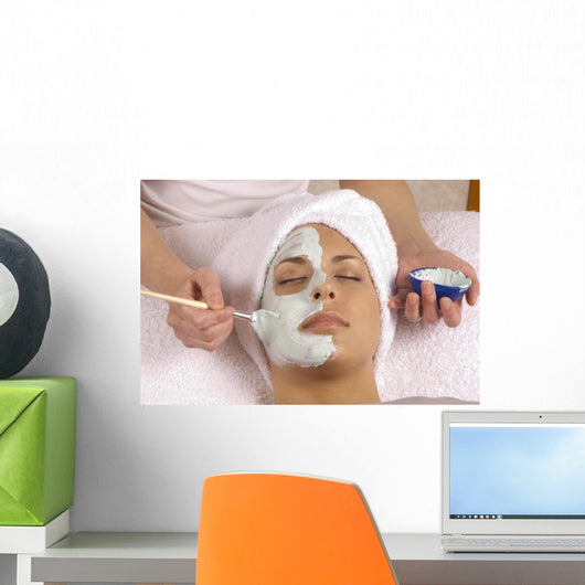 spa esthetician applying organic facial masque Wall Mural