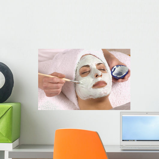 spa esthetician applying facial masque Wall Mural