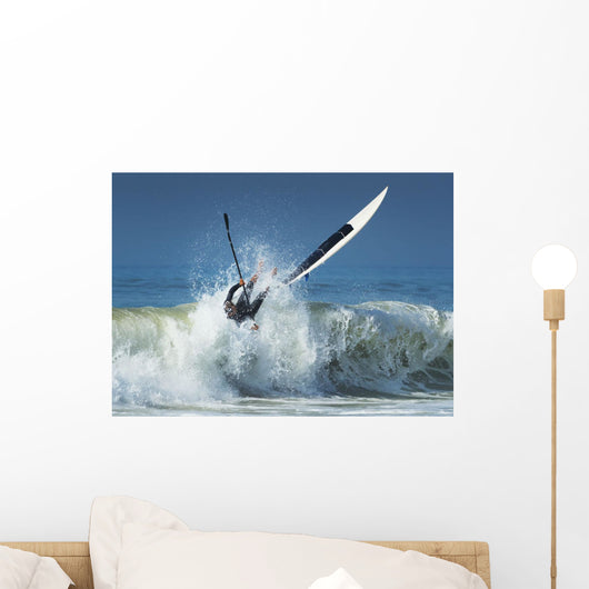Falling off paddleboard into water Wall Mural