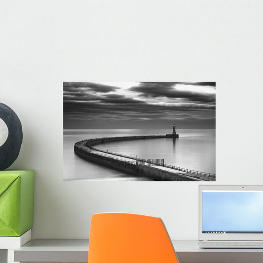 A curving pier with a lighthouse Wall Mural