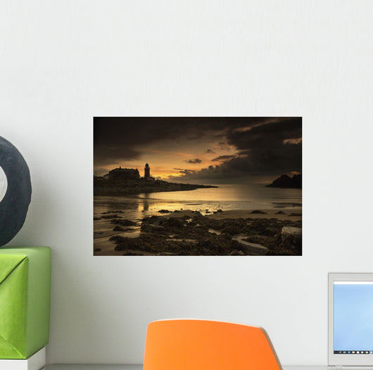 Silhouette of a lighthouse along the coast Wall Mural