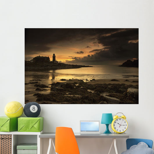 Silhouette of a lighthouse along the coast Wall Mural