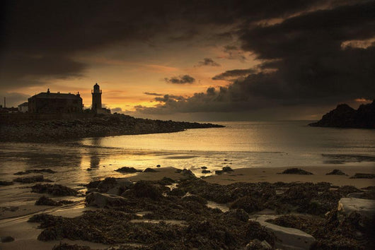 Silhouette of a lighthouse along the coast Wall Mural