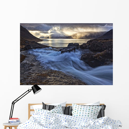 A stormy sky breaks above the Arnarfjorour fjord Wall Mural