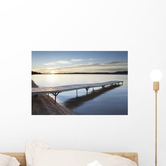 A dock in lake superior at sunset;Thunder bay, ontario, canada Wall Mural