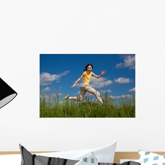 Girl Jumping Running against Wall Mural