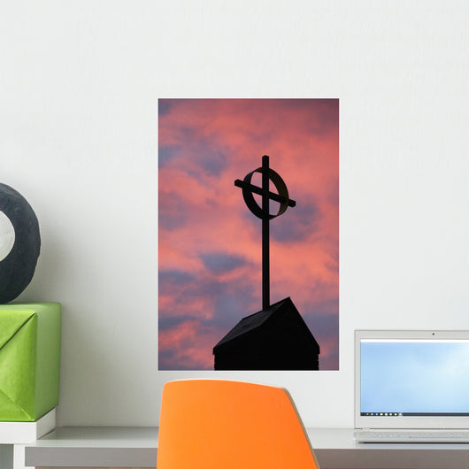 Silhouette of a cross on church steeple with fiery cloud cover Wall Mural