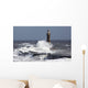 Waves crashing into a lighthouse Wall Mural