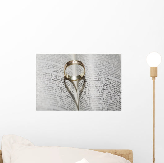 Close up of a gold ring with the shadow of an heart Wall Mural