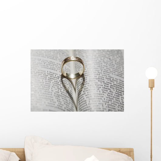 Close up of a gold ring with the shadow of an heart Wall Mural